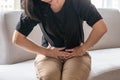 Abdominal pain in woman with stomachache illness from menstruation cramps, stomach cancer, irritable bowel syndrome