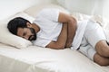 Abdominal Pain. Young Indian Man Suffering Stomach Ache While Lying In Bed Royalty Free Stock Photo