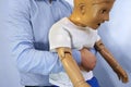 Abdominal thrusts the Heimlich maneuver or Heimlich manoeuvre on a simulation mannequin child dummy during medical training