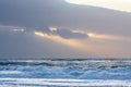 Evening sun behind rainy clouds