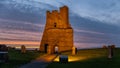 Aberystwyth Castle is beautifully lit after sunset.