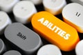 Abilities - possession of the qualities required to do something, necessary skill, competence or power, text concept button on