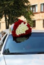 A huge bouquet of hundreds of red and white roses on the roof of the car Royalty Free Stock Photo