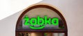 ÃÂ»abka store front company logo symbol front view, shop facade up close. Zabka Polish chain convenience store commerce retail