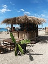 Abkhazia, Gagra 05.09.2021. Bar gazebo in tropical style made of bamboo and with a thatched roof on the beach of small Royalty Free Stock Photo