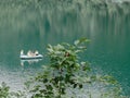 Abkhazia, Lake Ritsa 05.09.2021. Tourists ride in an inflatable boat on a smooth clear mountain lake in a national Royalty Free Stock Photo