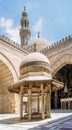 Ablution fountain at historic Sultan Barquq Mosque with dome and minaret in background, Cairo, Egypt
