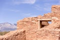 Abo Ruins, New Mexico. Mission wall, window, and Manzano Mountains in the distance. Full sunshine, blue sky Royalty Free Stock Photo