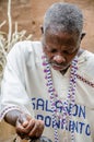 Abomey, Benin - March 07, 2014: African voodoo priest looking down concentrated while performing religious ritual