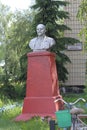 Abondoned monument to Vladimir Lenin left beside rural store, writing on a sign in Ukrainian - store of Lenin farm. Mena