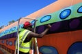 Aboriginal Australian artist painting on a storage tank