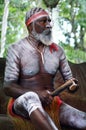 Aboriginal Australians man play Aboriginal music with Clapstick Royalty Free Stock Photo