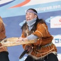 Aboriginal dancer in national clothes of native people emotional dancing with tambourine. Concert Koryak Dance Ensemble Mengo