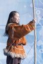 Aboriginal female emotional dancing with spear in national clothes indigenous people. Kamchatka Koryak National Dance