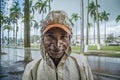 An aboriginal malagasy guy under the rain on the street