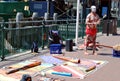 Aboriginal male street busker is giving performance with musical instruments laid out nearby on the ground at Circular