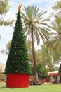 Aboriginals around a decorated Christmas tree in Alice Springs, Australia