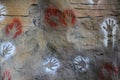 Aborigine art hands on stone wall