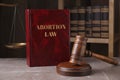 Abortion Law book, gavel and scales of justice on brown marble table Royalty Free Stock Photo