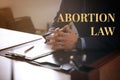 Abortion law. Male lawyer at table in office, closeup