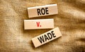 Abortion process Roe versus Wade symbol. Concept words Roe versus Wade on wooden blocks. Beautiful canvas table canvas background