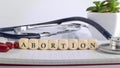 ABORTION word made with building blocks, medical concept background