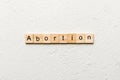 abortion word written on wood block. abortion text on table, concept