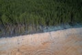 Above the border of a quarry advancing on the forest