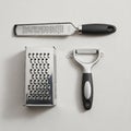 Above both is a flat microplane grater with a long handle, suitable for zesting Royalty Free Stock Photo