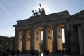 Above the Brandenburg Gate stands the Goddess of Victory in a chariot drawn by four horses heading towards the city. Royalty Free Stock Photo