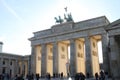 Above the Brandenburg Gate stands the Goddess of Victory in a chariot drawn by four horses heading towards the city.