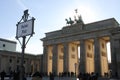 Above the Brandenburg Gate stands the Goddess of Victory in a chariot drawn by four horses heading towards the city.