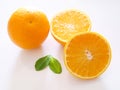 Above of bright citrus orange fruits with half orange and green leaf isolated on white background Royalty Free Stock Photo