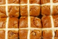 Above close up of a batch of hot cross buns