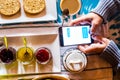 Above close up view of caucasian people use modern cellular phone internet and social media connected  during breakfast time at Royalty Free Stock Photo