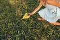 Above closeup view image of little girl playing with a paper plane in summer day in park. Cute kid throwing a paper airplane Royalty Free Stock Photo