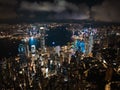 Above cloud cityscape of Hong Kong island, drone aerial night view. Skyscraper buildings in financial district Royalty Free Stock Photo