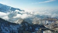 Above the clouds in the snowy mountains. Growing green spruce. Ate covered with snow. Royalty Free Stock Photo