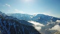 Above the clouds in the snowy mountains. Growing green spruce. Ate covered with snow. Royalty Free Stock Photo