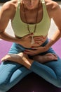 Woman meditating in Lotus pose and breathing