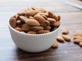 Above of dried almonds in bowl isolated on wooden table Royalty Free Stock Photo