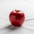 From above. The fabric beneath the apple has soft folds adding Royalty Free Stock Photo