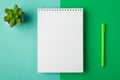 Above flat lay close up overhead view photo of clear open with copyspace note pad on spiral lying on half turquoise and light Royalty Free Stock Photo