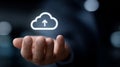 Above the hand floats a digital cloud icon with an upward-pointing arrow, symbolizing cloud storage or data upload. Royalty Free Stock Photo
