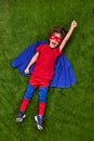 Excited superhero flying over lawn