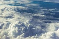 Above heaven concept, view from airplane to fluffy white clouds and blue atmosphere, nature skyline landscape Royalty Free Stock Photo