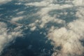 Above heaven concept, view from airplane to fluffy white clouds and earth