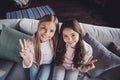 Above high angle view of two nice sweet adorable lovely attractive cheerful cheery girls embracing showing v-sign