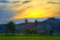 Antique Beautiful Sunset Behind Clouds and Hill With Green Plants and Trees Royalty Free Stock Photo