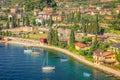 Above idyllic Lake Garda with sailboats in Malcesine at sunrise, Italian alps Royalty Free Stock Photo
